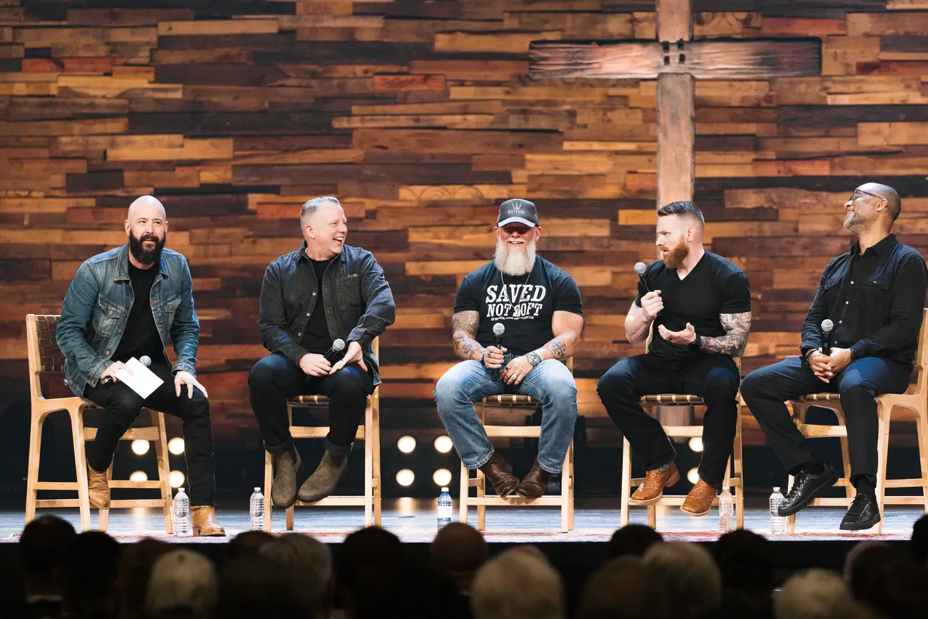 Five men seated on stage for a panel conversation